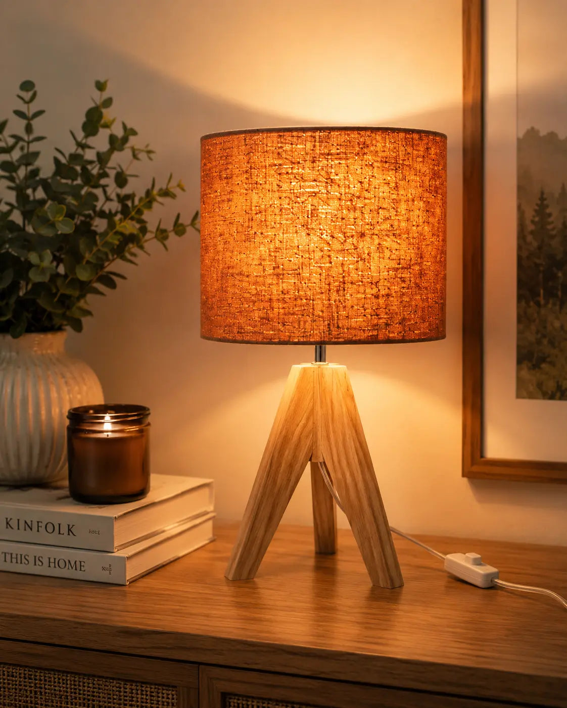 Modern wooden tripod table lamp with linen fabric shade on a bedside table, perfect for bedroom, living room and cozy home lighting