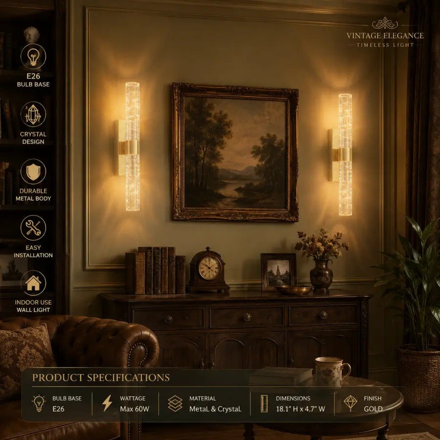 A pair of vintage-style crystal wall sconces mounted on either side of a framed landscape painting above a wooden console table in a warmly lit room. The sconces have a gold-toned metal frame with clear crystal glass tubes that glow with warm light.