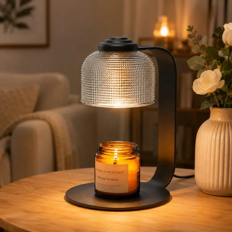Black candle warmer lamp with timer and dimmer warming a scented jar candle on a wooden table in a modern living room