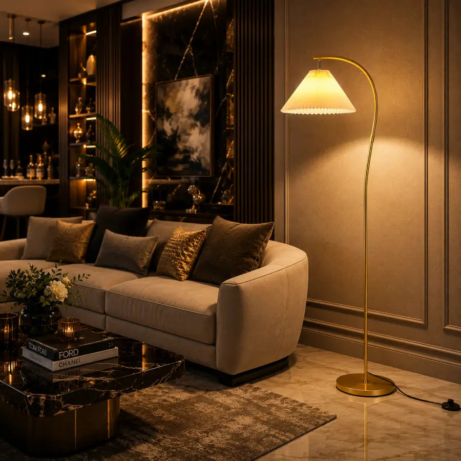 A modern living room scene featuring a tall gold floor lamp with a conical shade next to a beige sofa with decorative pillows, set against a dark wood-paneled wall.